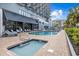 Outdoor pool area with hot tub and lounge chairs at condo resort at 2001 S Ocean Blvd. # 920, Myrtle Beach, SC 29577