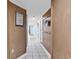 Hallway features wood paneled walls, white tile flooring, and decorative accents, creating a welcoming space at 205 74Th Ave. N # 1607, Myrtle Beach, SC 29577