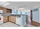Open kitchen featuring light wood cabinets, white appliances, granite countertops, and a view into the living area at 205 74Th Ave. N # 1607, Myrtle Beach, SC 29577