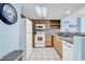 Bright kitchen featuring white appliances, light wood cabinets, granite countertops, and tiled flooring at 205 74Th Ave. N # 1607, Myrtle Beach, SC 29577