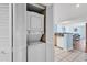 Condo laundry area featuring a stacked washer and dryer, with a partial view of the kitchen and living area at 205 74Th Ave. N # 1607, Myrtle Beach, SC 29577