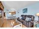 Cozy living room with a leather sofa, a decorative coffee table, and a view of the open kitchen and dining area at 205 74Th Ave. N # 1607, Myrtle Beach, SC 29577