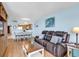 Inviting living room with a leather sofa, a decorative coffee table, and a view of the open kitchen and dining area at 205 74Th Ave. N # 1607, Myrtle Beach, SC 29577