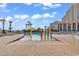 Community pool area with colorful water features and palm trees at 205 74Th Ave. N # 1607, Myrtle Beach, SC 29577