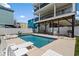 Backyard featuring a pristine pool, lounge chairs, and the multi-story home's exterior at 221 N Waccamaw Dr., Murrells Inlet, SC 29576