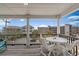 Balcony with a white table and chairs with serene views of nearby houses and beach at 221 N Waccamaw Dr., Murrells Inlet, SC 29576