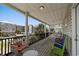 Inviting balcony with colorful seating, a cozy wicker chair, and views of nearby homes at 221 N Waccamaw Dr., Murrells Inlet, SC 29576