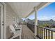 Inviting balcony featuring white rocking chairs and a pleasant view of the neighborhood at 221 N Waccamaw Dr., Murrells Inlet, SC 29576