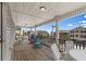 Charming balcony featuring colorful rocking chairs, columns and a lovely view of the community at 221 N Waccamaw Dr., Murrells Inlet, SC 29576