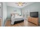 Comfortable bedroom offering hardwood floors, a ceiling fan, a double bed and access to a balcony at 221 N Waccamaw Dr., Murrells Inlet, SC 29576
