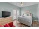 Inviting bedroom with hardwood floors, tv, light blue walls, a double bed, and access to a balcony at 221 N Waccamaw Dr., Murrells Inlet, SC 29576