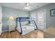 Light bedroom with a bunk bed, light blue walls, hardwood floors, and access to a balcony at 221 N Waccamaw Dr., Murrells Inlet, SC 29576
