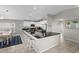 Modern kitchen with white cabinets and a large island with barstool seating at 221 N Waccamaw Dr., Murrells Inlet, SC 29576