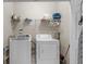Functional laundry room equipped with a washer, a dryer, and ample shelving for storage solutions at 221 N Waccamaw Dr., Murrells Inlet, SC 29576