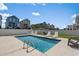 Backyard pool with lounge chairs and a white privacy fence at 221 N Waccamaw Dr., Murrells Inlet, SC 29576