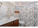 Classic bathroom with wood vanity and a mirror, and a blue floral shower curtain at 221 Rivers Edge Dr., Conway, SC 29526