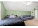 Cozy bedroom with a comfortable bed and a gray sofa under a ceiling fan at 221 Rivers Edge Dr., Conway, SC 29526