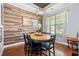 Dining room featuring a wood accent wall, round table with chairs, and a modern chandelier at 221 Rivers Edge Dr., Conway, SC 29526