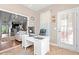 Home office with a white desk and view into the open floor plan featuring the kitchen and living room at 221 Rivers Edge Dr., Conway, SC 29526
