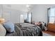 Main bedroom features a ceiling fan, ensuite bathroom, and a comfortable seating area by the window at 221 Rivers Edge Dr., Conway, SC 29526
