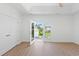 Bright, spacious main bedroom with wood flooring and glass doors leading to a balcony at 2241 Sand Dunes Dr., Myrtle Beach, SC 29577