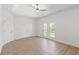 Bedroom showcasing wood floors, light walls, ceiling fan, and a balcony at 2241 Sand Dunes Dr., Myrtle Beach, SC 29577