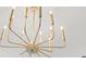 Close up of a modern, gold light fixture with twelve lights at 2241 Sand Dunes Dr., Myrtle Beach, SC 29577