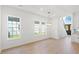 Bright dining room with wood floors, a modern chandelier, and ample natural light at 2241 Sand Dunes Dr., Myrtle Beach, SC 29577