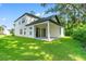 Exterior view of home showcasing white siding, covered patio, and spacious backyard at 2241 Sand Dunes Dr., Myrtle Beach, SC 29577