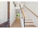 Bright foyer with wooden stairs and wood floors leading into the living space at 2241 Sand Dunes Dr., Myrtle Beach, SC 29577