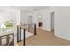 Upstairs hallway featuring modern light fixture, wooden banister, and wood flooring at 2241 Sand Dunes Dr., Myrtle Beach, SC 29577