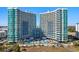 Stunning aerial view of oceanfront resort highlighting pool, beach access, and modern architecture at 300 N Ocean Blvd. # 128, North Myrtle Beach, SC 29582