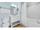 Well-lit bathroom with a shower-tub combo and a vanity with drawer storage and a shelf at 300 N Ocean Blvd. # 128, North Myrtle Beach, SC 29582