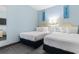 This bedroom includes two beds, coastal decor, and a mirrored closet at 300 N Ocean Blvd. # 128, North Myrtle Beach, SC 29582