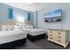 Charming bedroom with two queen beds, cozy carpet, and relaxing beachfront art, complete with a flatscreen TV at 300 N Ocean Blvd. # 128, North Myrtle Beach, SC 29582