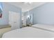 Bright bedroom features two beds, a closet, and a doorway leading to a kitchen, offering comfort and convenience at 300 N Ocean Blvd. # 128, North Myrtle Beach, SC 29582