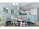 Open-concept dining area with a table for six, adjacent to the kitchen and comfortable seating area at 300 N Ocean Blvd. # 128, North Myrtle Beach, SC 29582