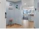Charming entryway with beach-themed decor, opening to kitchen and living area with ocean views at 300 N Ocean Blvd. # 128, North Myrtle Beach, SC 29582