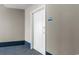 Hallway view leading to unit door, with neutral paint, blue accents, and visible unit number at 300 N Ocean Blvd. # 128, North Myrtle Beach, SC 29582