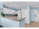Well-equipped kitchen with granite countertop, white cabinets, tile backsplash and modern appliances at 300 N Ocean Blvd. # 128, North Myrtle Beach, SC 29582