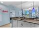 Bright and airy kitchen with granite countertops, white cabinets, and views of the living area and bedroom at 300 N Ocean Blvd. # 128, North Myrtle Beach, SC 29582