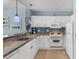 Modern kitchen featuring white cabinets, granite countertops, and stainless steel appliances for efficient cooking at 300 N Ocean Blvd. # 128, North Myrtle Beach, SC 29582