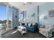 Bright and cheerful living room features an ocean view and comfortable furniture in a coastal style at 300 N Ocean Blvd. # 128, North Myrtle Beach, SC 29582