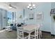 Bright living room features ocean view windows, a dining area, comfortable seating and coastal-themed decor at 300 N Ocean Blvd. # 128, North Myrtle Beach, SC 29582