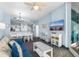 Bright living room with a large tv, a sofa with coastal pillows and easy access to the balcony at 300 N Ocean Blvd. # 128, North Myrtle Beach, SC 29582