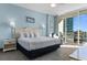 Main bedroom with balcony access and a view, plus a sitting area and light, coastal decor at 300 N Ocean Blvd. # 128, North Myrtle Beach, SC 29582