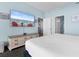 The main bedroom includes a large TV, coastal decor, and doorways to the kitchen and bathroom at 300 N Ocean Blvd. # 128, North Myrtle Beach, SC 29582