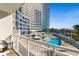 Inviting pool area with a building backdrop, palm trees, and beach views offers relaxation and scenic beauty at 300 N Ocean Blvd. # 128, North Myrtle Beach, SC 29582