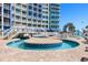 Relaxing outdoor pool area with unique water features and inviting sun deck for hotel guests at 300 N Ocean Blvd. # 128, North Myrtle Beach, SC 29582