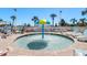 Outdoor splash pad with a vibrant umbrella fountain, surrounded by lounge chairs and palm trees at 300 N Ocean Blvd. # 128, North Myrtle Beach, SC 29582